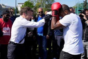 President Emmanuel Macron, at the Auguste Delaune stadium, at a campaign event in Saint-Denis.  (Photo by Francois Mori / POOL / AFP)