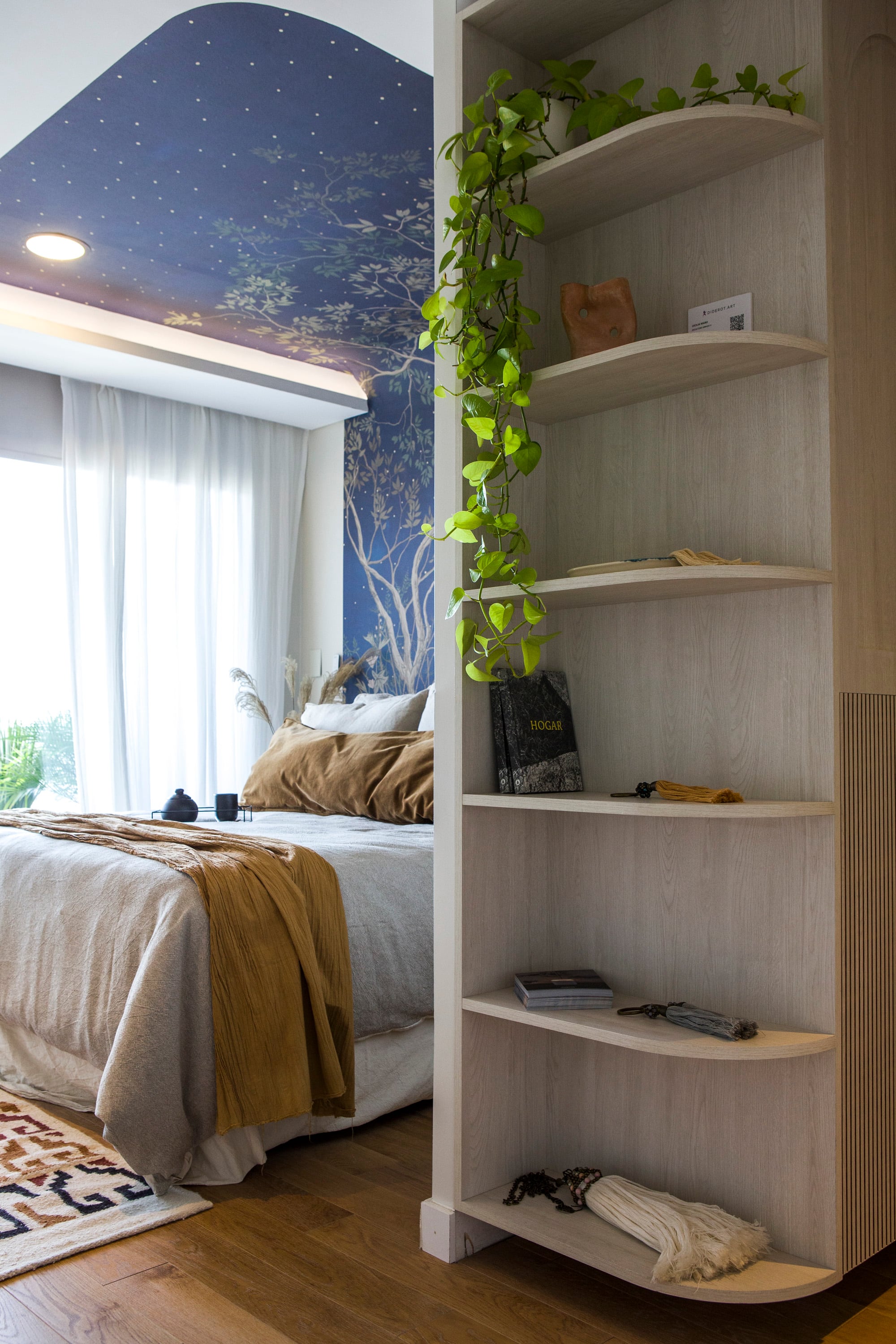 A shelving adds saved space to the bedroom prelude. The cotton gauze curtains are of their own clothing.